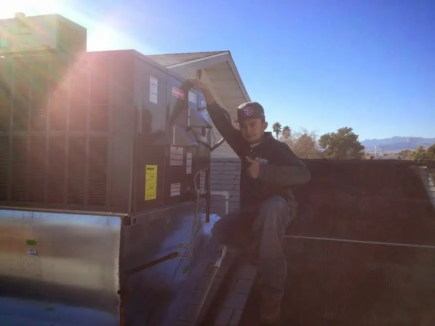 HVAC technician performing AC Tune-Up on a rooftop unit in Healdsburg